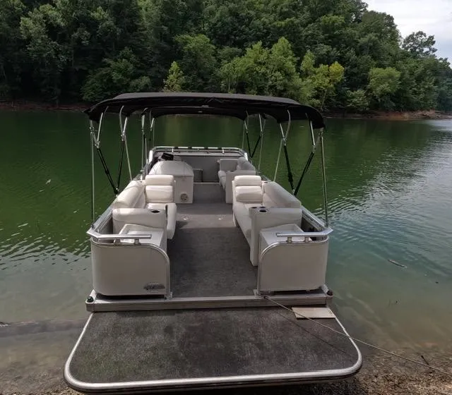 Slide: The Image of 1988 Sun Tracker PARTY BARGE pontoon boat on a serene lake. - 3
