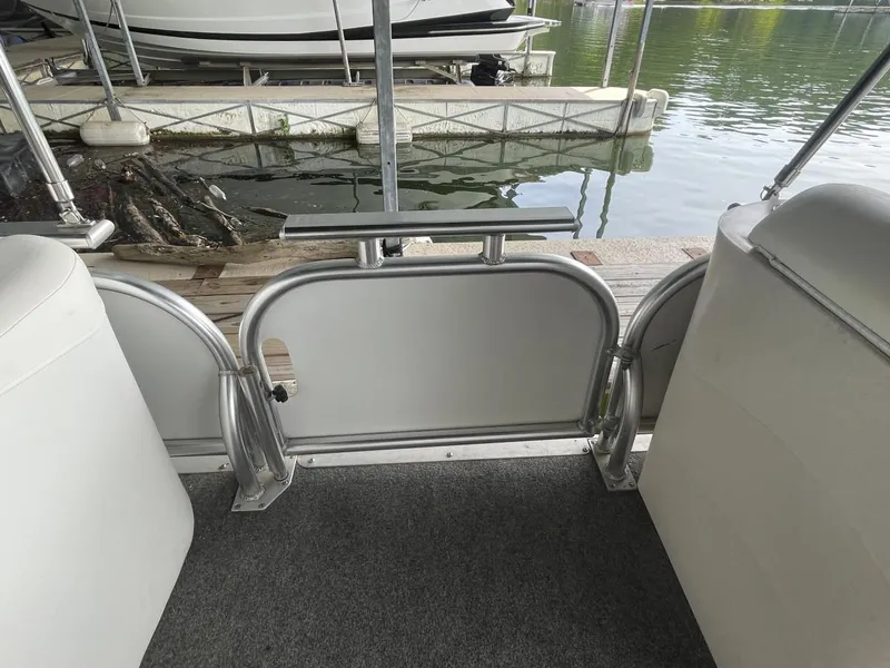 Slide: The Image of 1988 Sun Tracker PARTY BARGE interior, showing seating and dock view. - 31