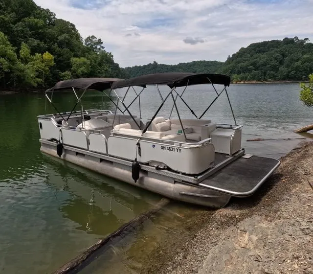 Slide: The Image of 1988 Sun Tracker PARTY BARGE pontoon boat docked on a scenic lake. - 6