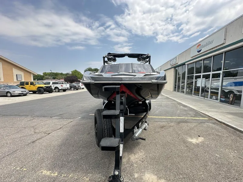 Slide: The Image of 2014 Tigé ASR boat on trailer in parking lot, cloudy sky background. - 10
