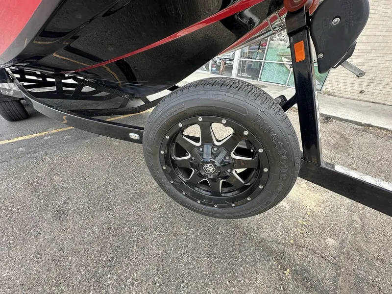 Slide: The Image of 2014 Tigé ASR boat trailer with black Firestone tire and alloy wheel. - 11