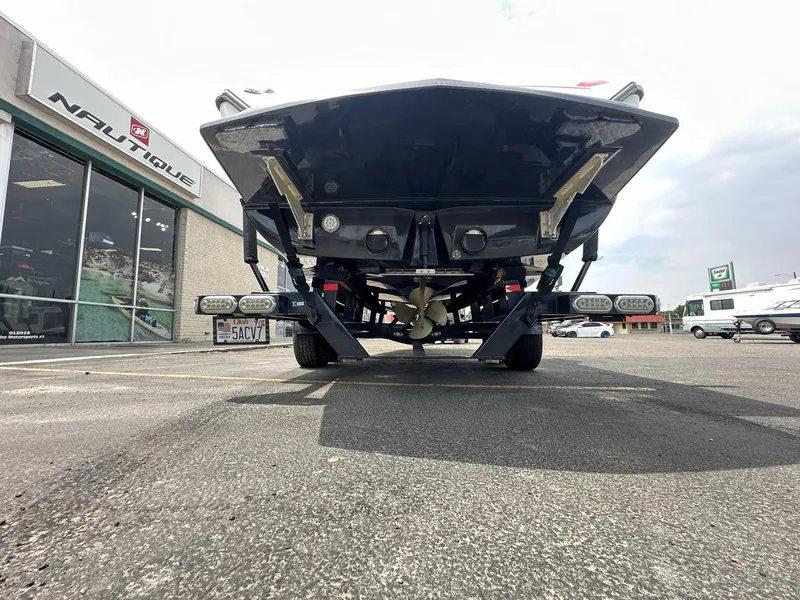 Slide: The Image of 2014 Tigé ASR boat on trailer outside Nautique dealership, rear view. - 12