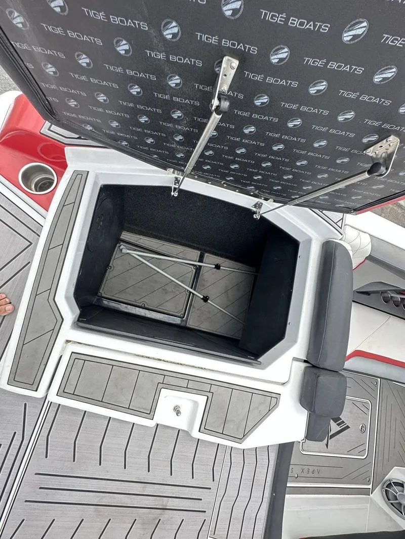 Slide: The Image of 2014 Tigé ASR boat storage compartment with open hatch, showcasing interior space and design. - 15