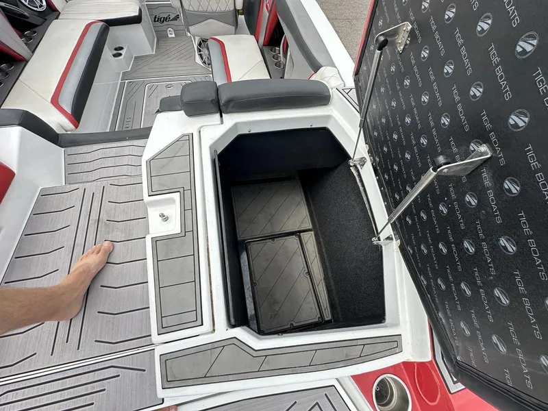 Slide: The Image of 2014 Tigé ASR boat interior with open storage compartment and seating area. - 16