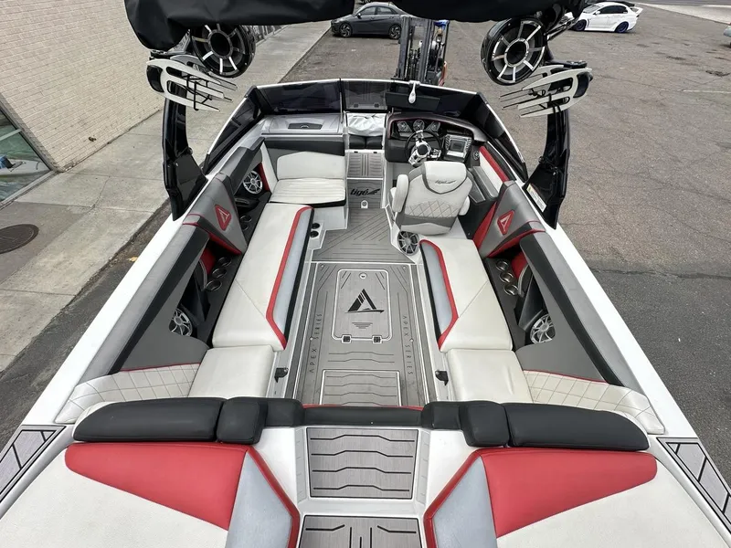 Slide: The Image of 2014 Tigé ASR boat interior with red and gray seating, advanced sound system, and sleek design. - 17