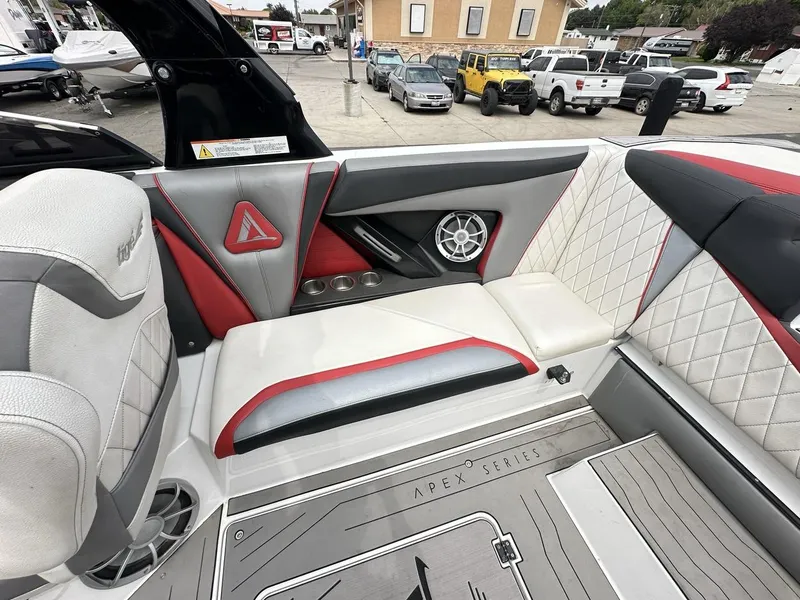 Slide: The Image of 2014 Tigé ASR boat interior with stylish seating, speaker, and cup holders. - 19