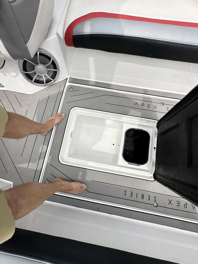 Slide: The Image of 2014 Tigé ASR boat interior with open storage compartment and speaker. - 23