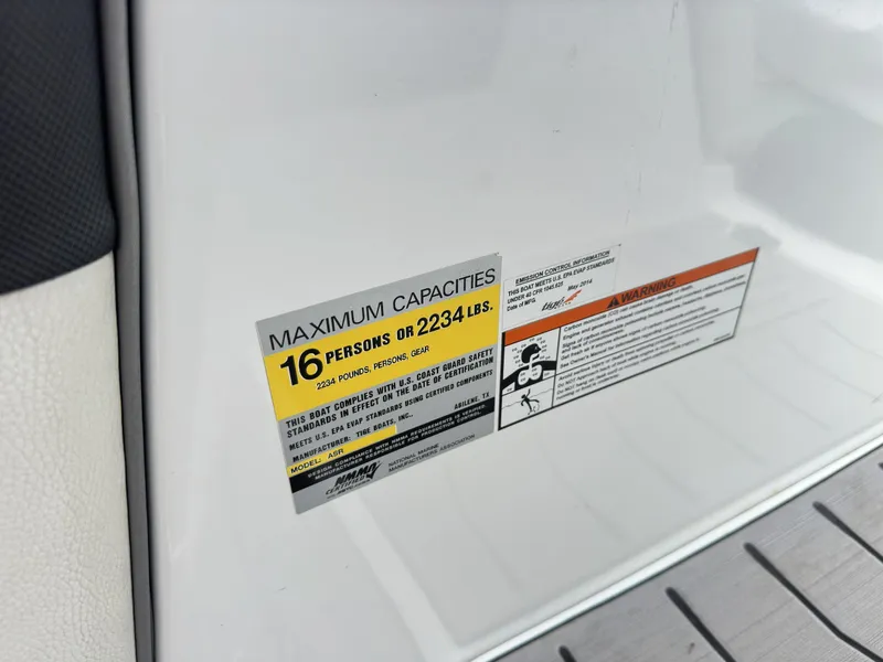 Slide: The Image of 2014 Tigé ASR capacity label, maximum 16 persons or 2234 lbs, safety compliance details. - 27