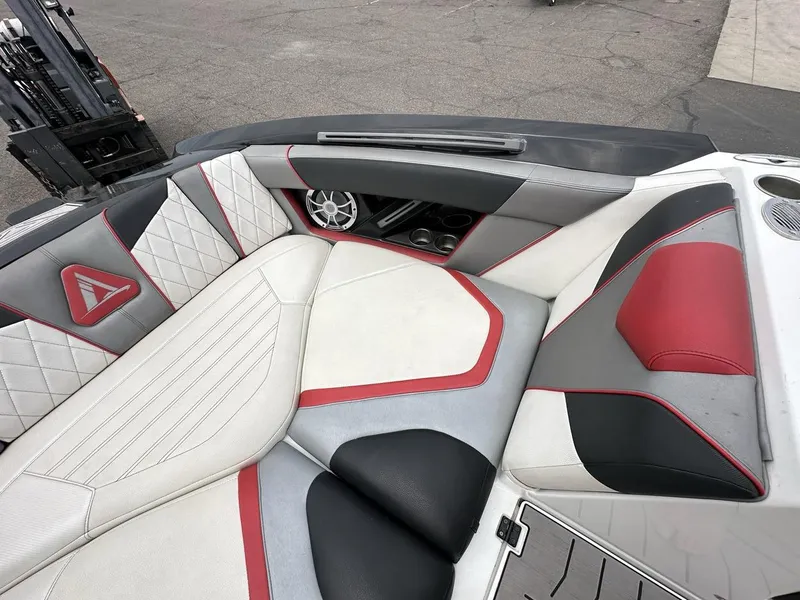 Slide: The Image of 2014 Tigé ASR boat interior with red, white, and gray seating and speaker system. - 30
