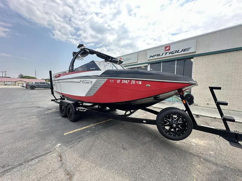 Slide: The Image of 2014 Tigé ASR boat on trailer, parked outside Nautique dealership. - 4