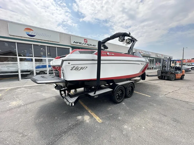 Slide: The Image of 2014 Tigé ASR boat on trailer outside dealership, showcasing sleek design and vibrant colors. - 5
