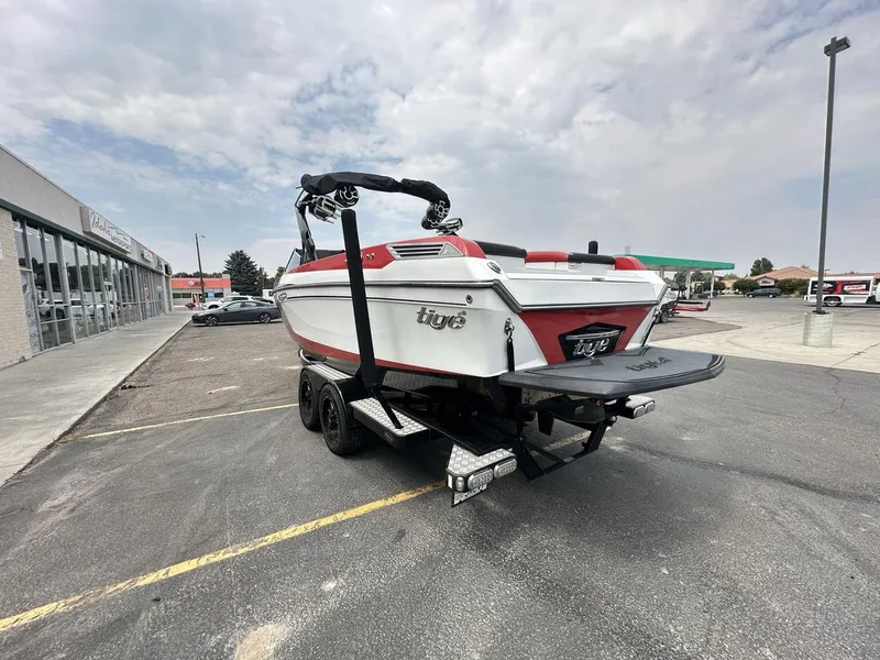 Slide: The Image of 2014 Tigé ASR boat on trailer in parking lot, overcast sky. - 7