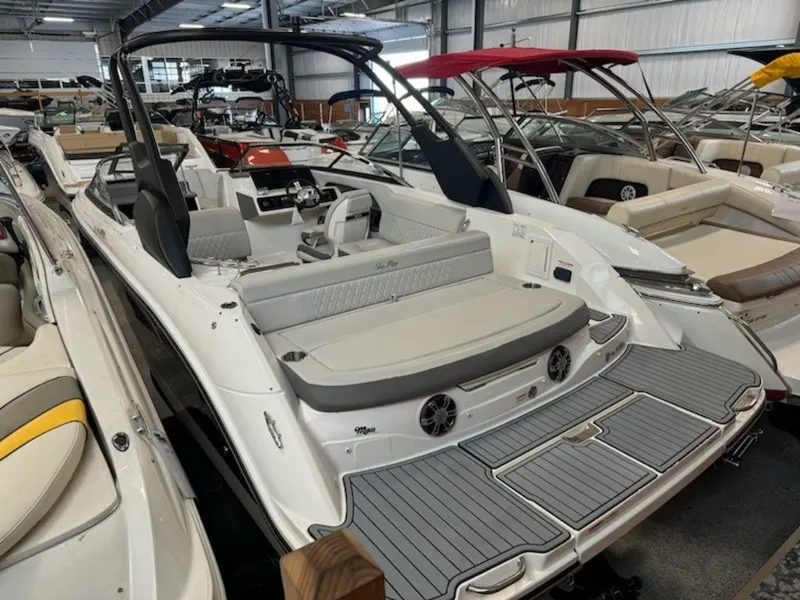 Slide: The Image of 2020 Sea Ray SLX 230 boat in showroom, featuring sleek design and spacious seating. - 2