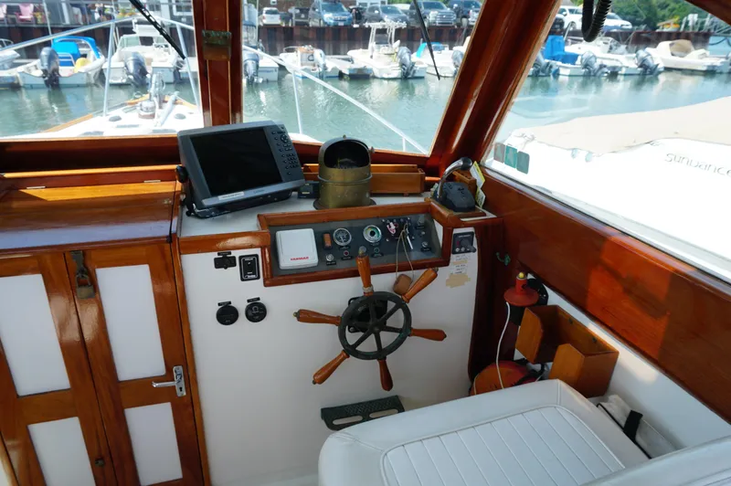 Slide: The Image of Helm of 2000 Webbers Cove 26 Pemaquid Beach boat with steering wheel and navigation equipment. - 11