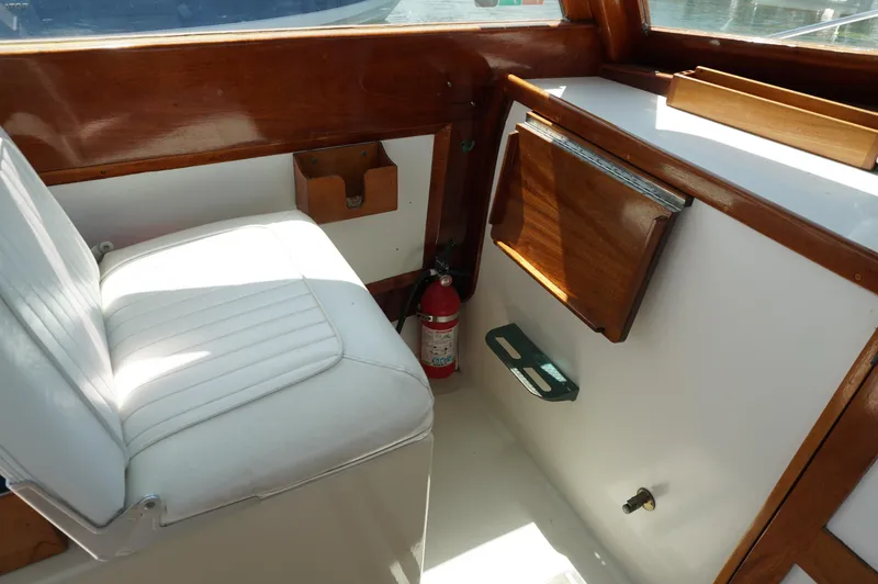 Slide: The Image of Interior of 2000 Webbers Cove 26 Pemaquid Beach boat with white seating and wooden accents. - 14