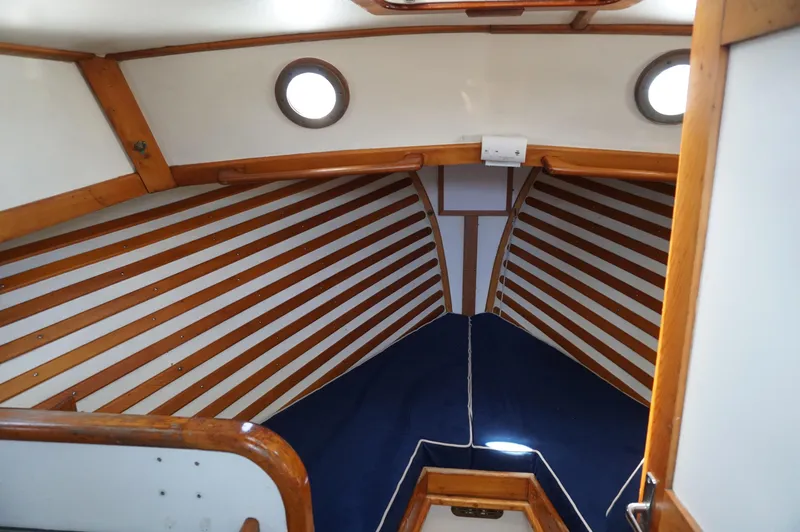 Slide: The Image of Interior of 2000 Webbers Cove 26 Pemaquid Beach boat with wood paneling and portholes. - 17