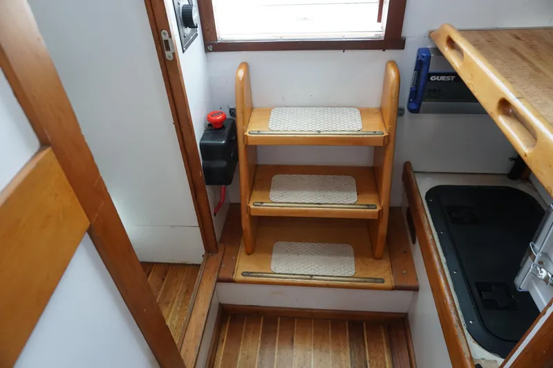 Slide: The Image of Interior of 2000 Webbers Cove 26 Pemaquid Beach boat with wooden steps and storage. - 19