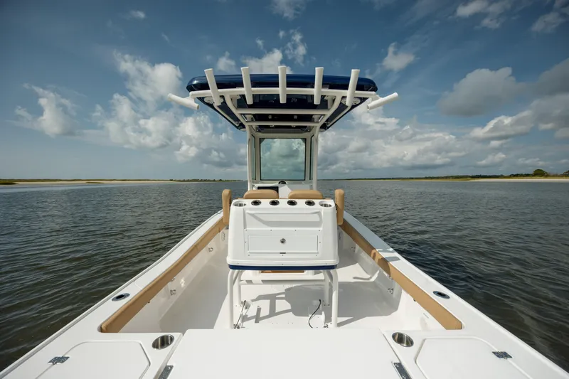 Slide: The Image of 2025 Caymas 26 HB boat on calm water under a cloudy sky. - 14