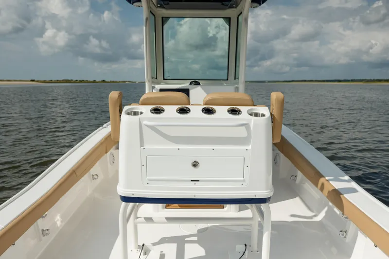 Slide: The Image of 2025 Caymas 26 HB boat interior with console and seating on calm water. - 15