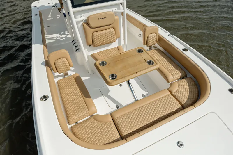 Slide: The Image of 2025 Caymas 26 HB boat interior with tan cushioned seating and table. - 20