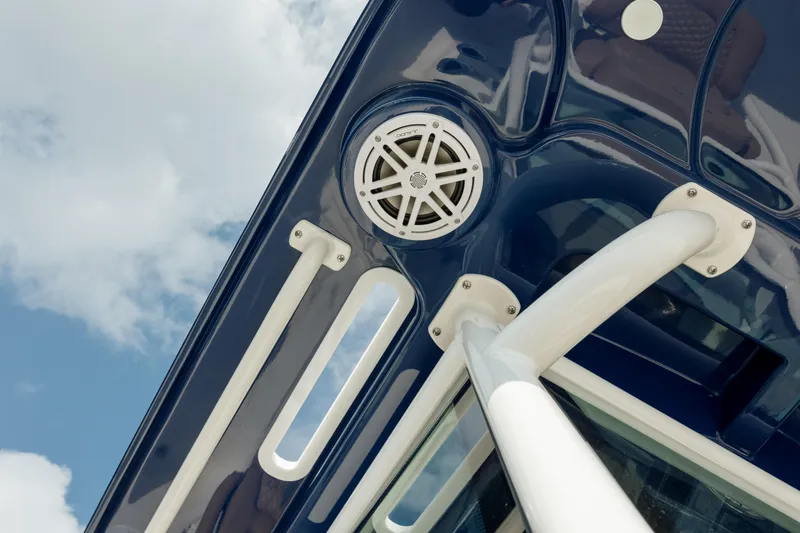 Slide: The Image of Close-up of 2025 Caymas 26 HB boat speaker and structure against blue sky. - 27