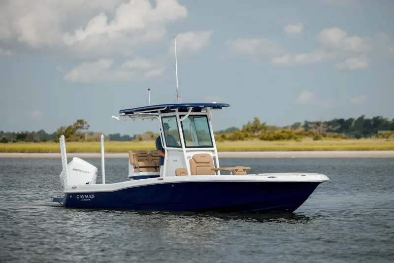 Slide: The Image of 2025 Caymas 26 HB boat on calm water, clear sky background. - 7