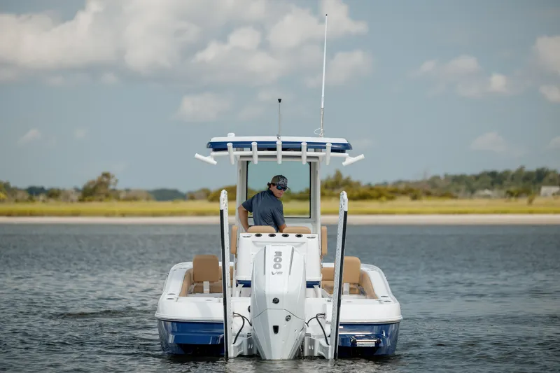 Slide: The Image of 2025 Caymas 26 HB boat on water, rear view with outboard motor. - 8