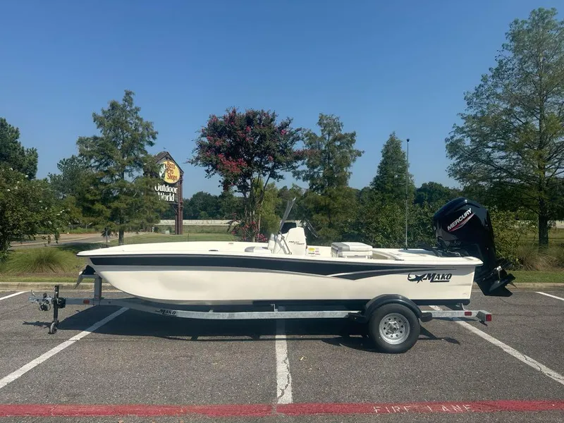 Slide: The Image of 2024 Mako Pro Skiff 17 CC boat on trailer in parking lot. - 0