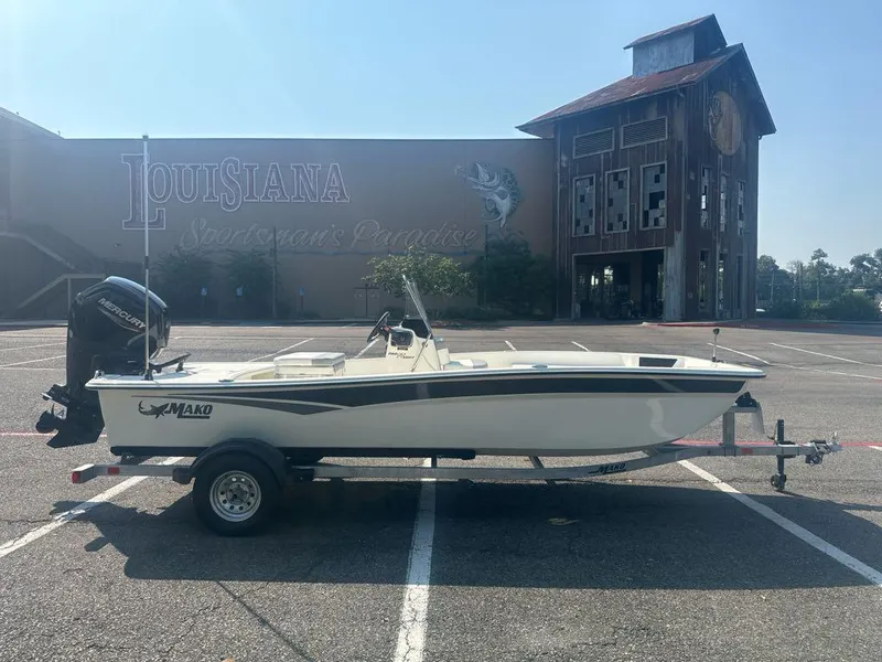 Slide: The Image of 2024 Mako Pro Skiff 17 CC boat on trailer in parking lot. - 2