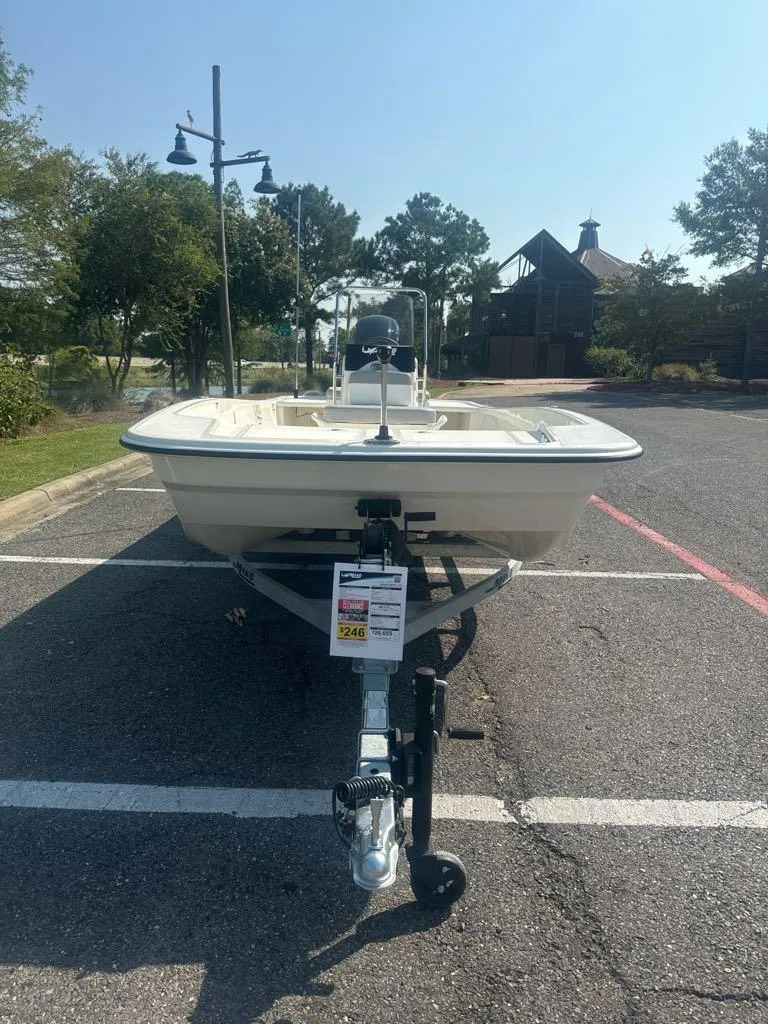 Slide: The Image of 2024 Mako Pro Skiff 17 CC boat on trailer in parking lot. - 3