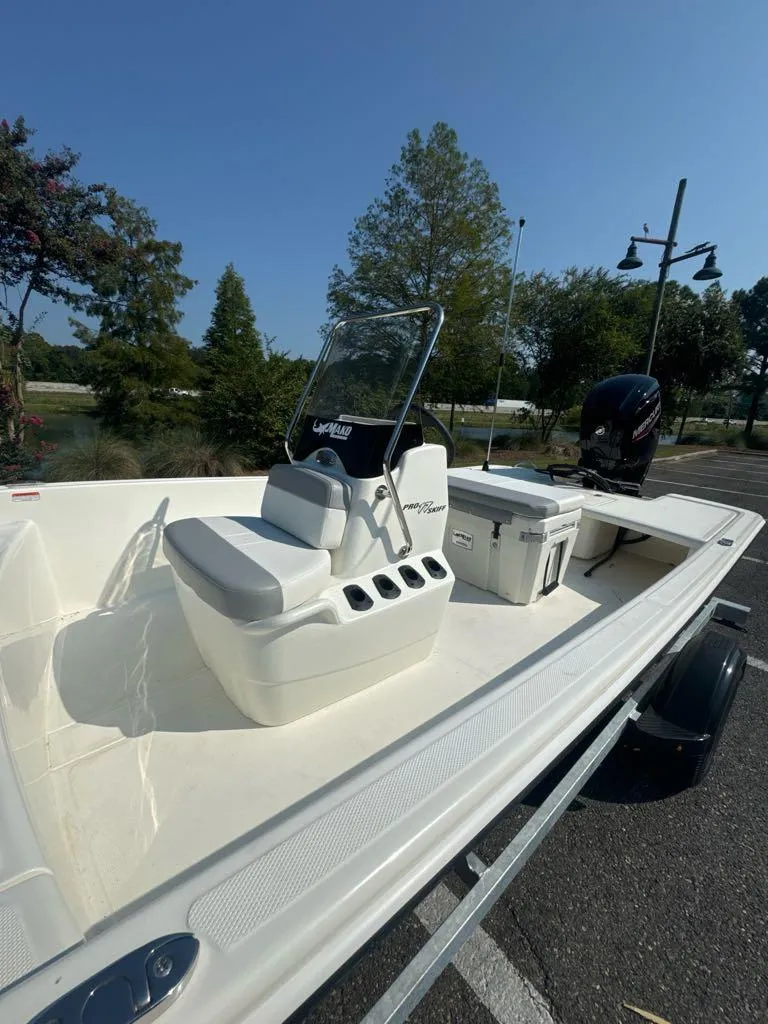 Slide: The Image of 2024 Mako Pro Skiff 17 CC boat on trailer, featuring center console and outboard motor. - 5