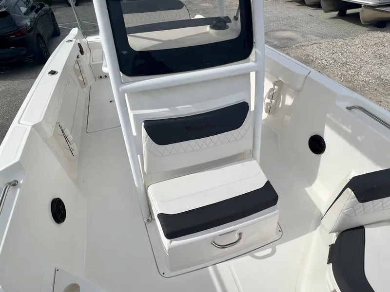 Slide: The Image of 2023 Trophy T24CC boat interior with white seating and storage compartments. - 21
