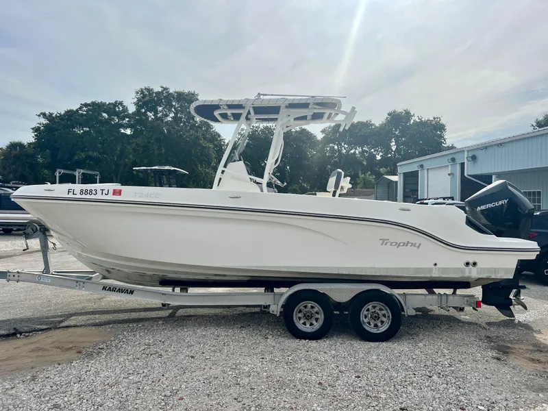 Slide: The Image of 2023 Trophy T24CC boat on trailer, parked outdoors, side view. - 4