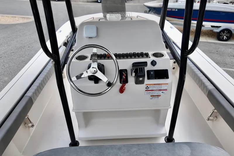 Slide: The Image of 2025 Carolina Skiff 26 Ultra Elite boat console with steering wheel and controls. - 12
