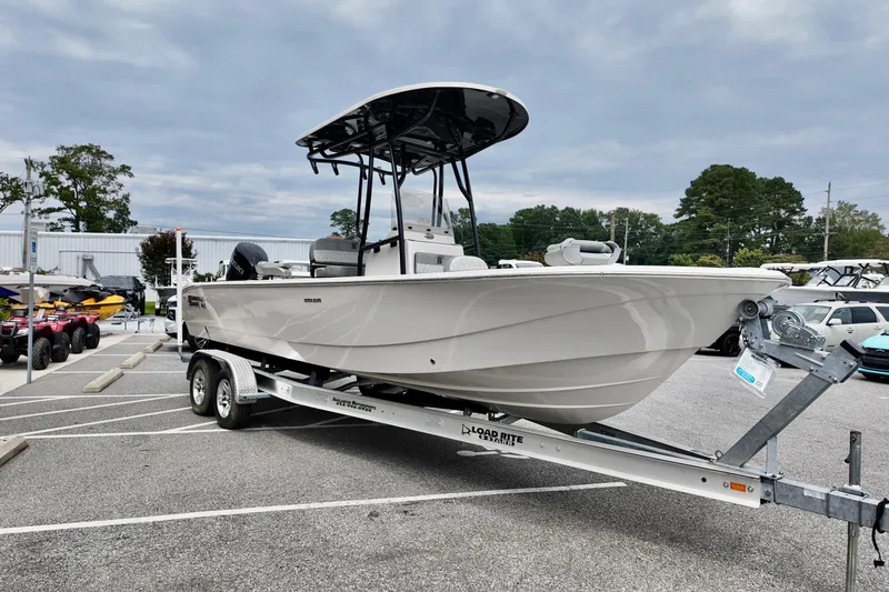 Slide: The Image of 2025 Carolina Skiff 26 Ultra Elite boat on trailer in parking lot. - 14