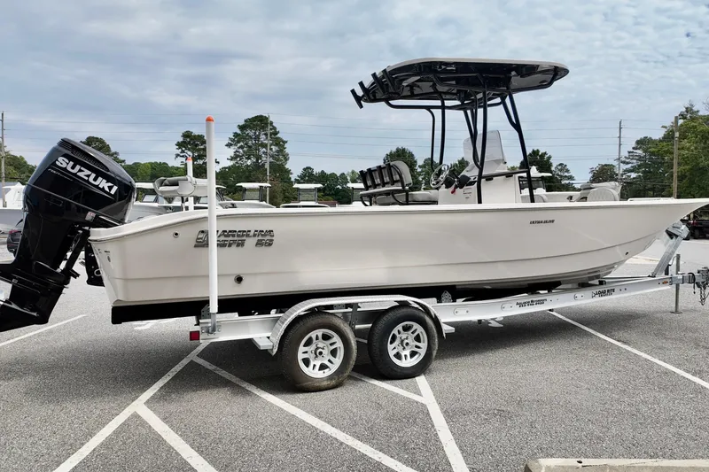 Slide: The Image of 2025 Carolina Skiff 26 Ultra Elite boat on trailer, featuring Suzuki outboard motor. - 6