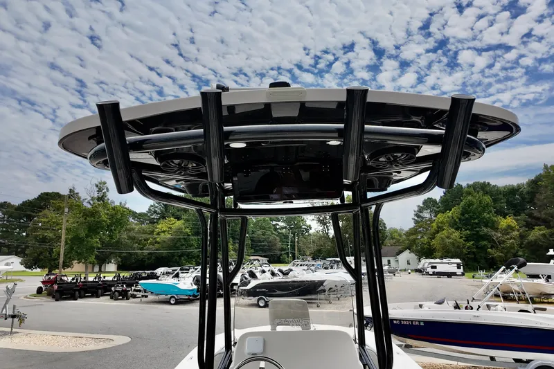 Slide: The Image of 2025 Carolina Skiff 26 Ultra Elite boat with T-top, under a partly cloudy sky. - 7