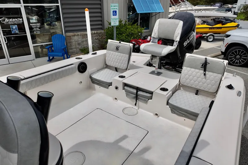 Slide: The Image of 2025 Carolina Skiff 26 Ultra Elite boat interior with seating and Suzuki engine. - 9