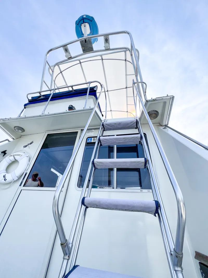 Slide: The Image of 1987 Tollycraft 34 Sport Sedan boat with ladder and upper deck view. - 10
