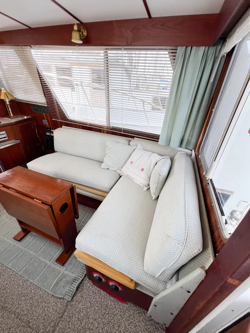 Slide: The Image of Interior of 1987 Tollycraft 34 Sport Sedan with cozy seating and wooden accents. - 23
