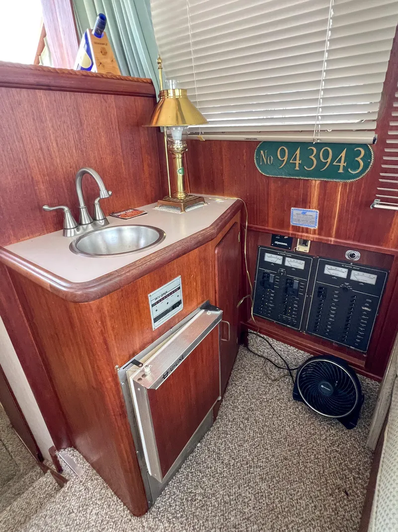 Slide: The Image of 1987 Tollycraft 34 Sport Sedan interior with sink, lamp, and control panel. - 27