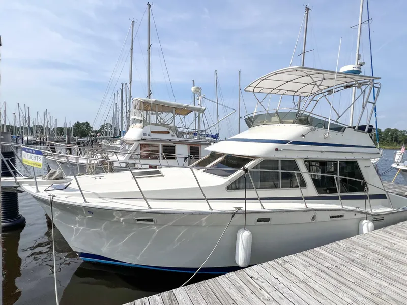 Slide: The Image of 1987 Tollycraft 34 Sport Sedan docked at marina, featuring sleek design and spacious deck. - 8