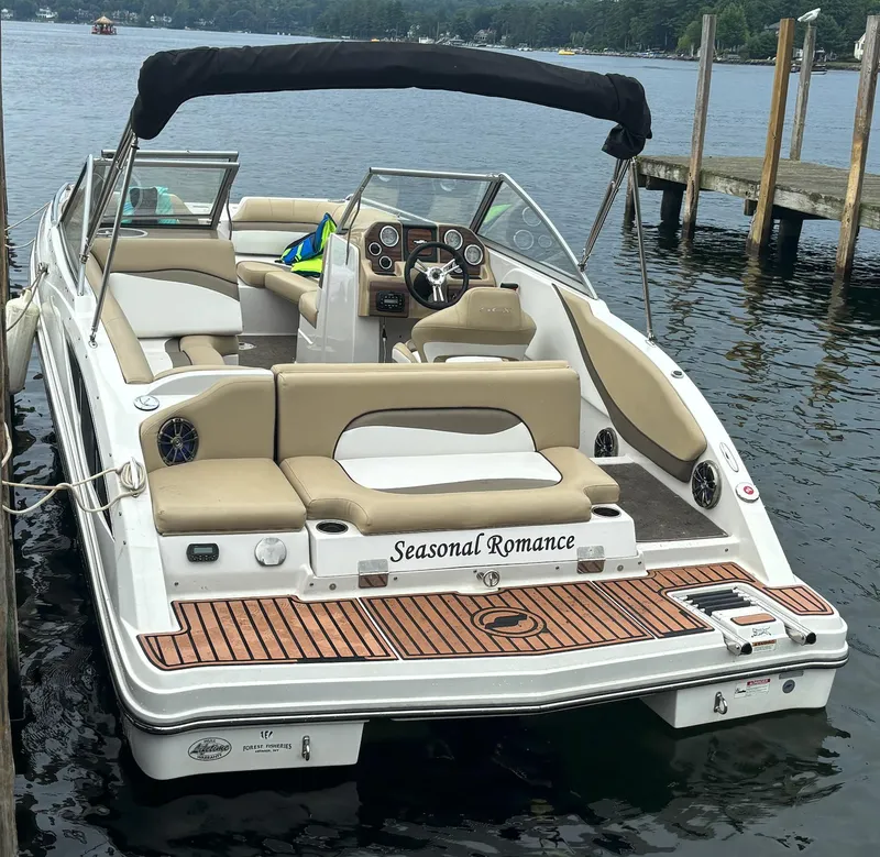 Slide: The Image of 2014 Starcraft SCX 230 boat docked, featuring "Seasonal Romance" on the stern. - 13