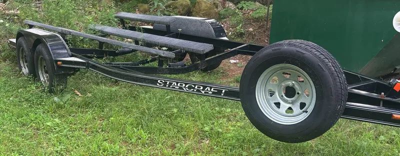 Slide: The Image of 2014 Starcraft SCX 230 boat trailer on grass. - 21