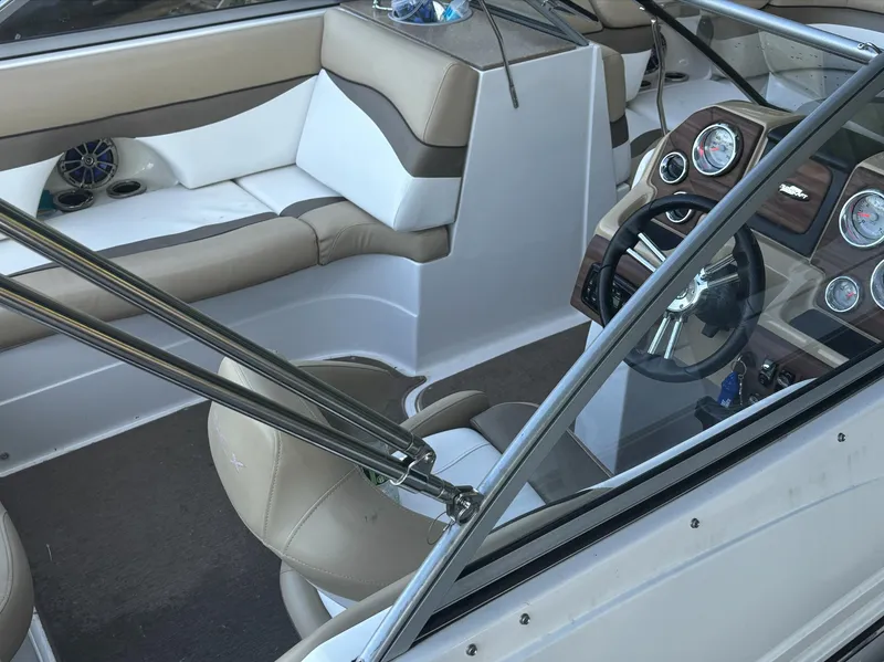 Slide: The Image of Interior of 2014 Starcraft SCX 230 boat with beige seating and modern dashboard. - 5
