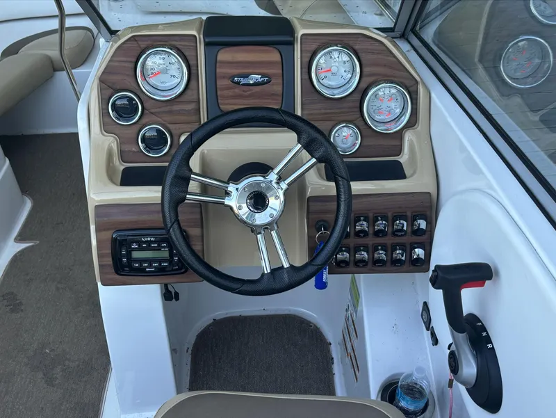 Slide: The Image of 2014 Starcraft SCX 230 boat dashboard with steering wheel and gauges. - 8