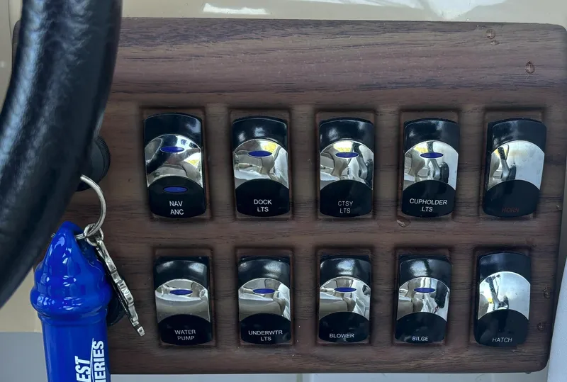 Slide: The Image of Control panel of a 2014 Starcraft SCX 230 boat with labeled switches. - 9