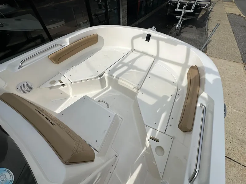 Slide: The Image of 2024 Bayliner Trophy T20CC boat interior with cushioned seating and storage compartments. - 11