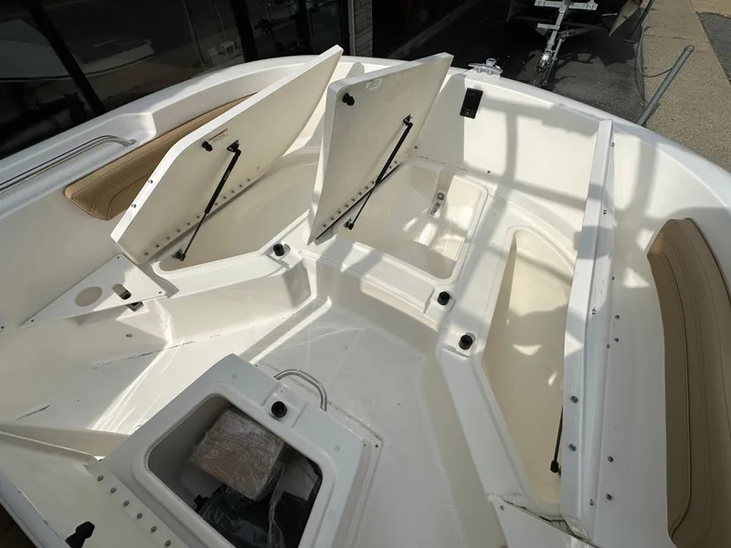 Slide: The Image of 2024 Bayliner Trophy T20CC boat with open storage compartments. - 12