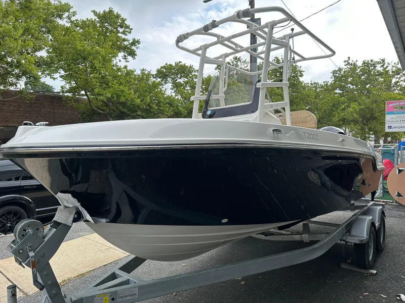 Slide: The Image of 2024 Bayliner Trophy T20CC boat on trailer, parked outdoors. - 2